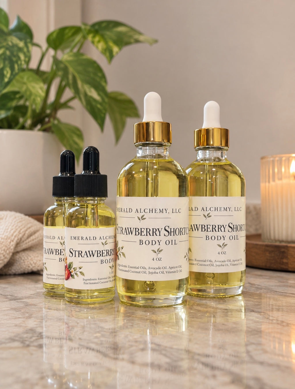 Four Strawberry Shortcake body oil bottles in 1 oz and 4 oz sizes