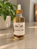 Clove body and massage oil in a 4 oz glass dropper bottle