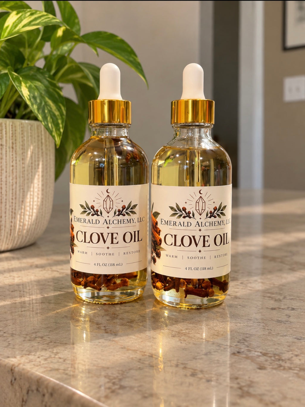 Two 4 oz bottles of clove body and massage oil
