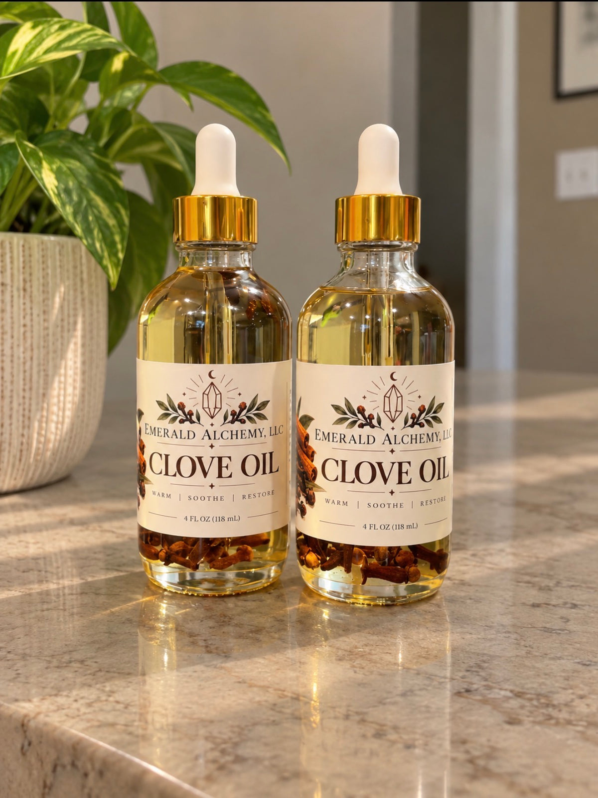 Two 4 oz bottles of clove body and massage oil