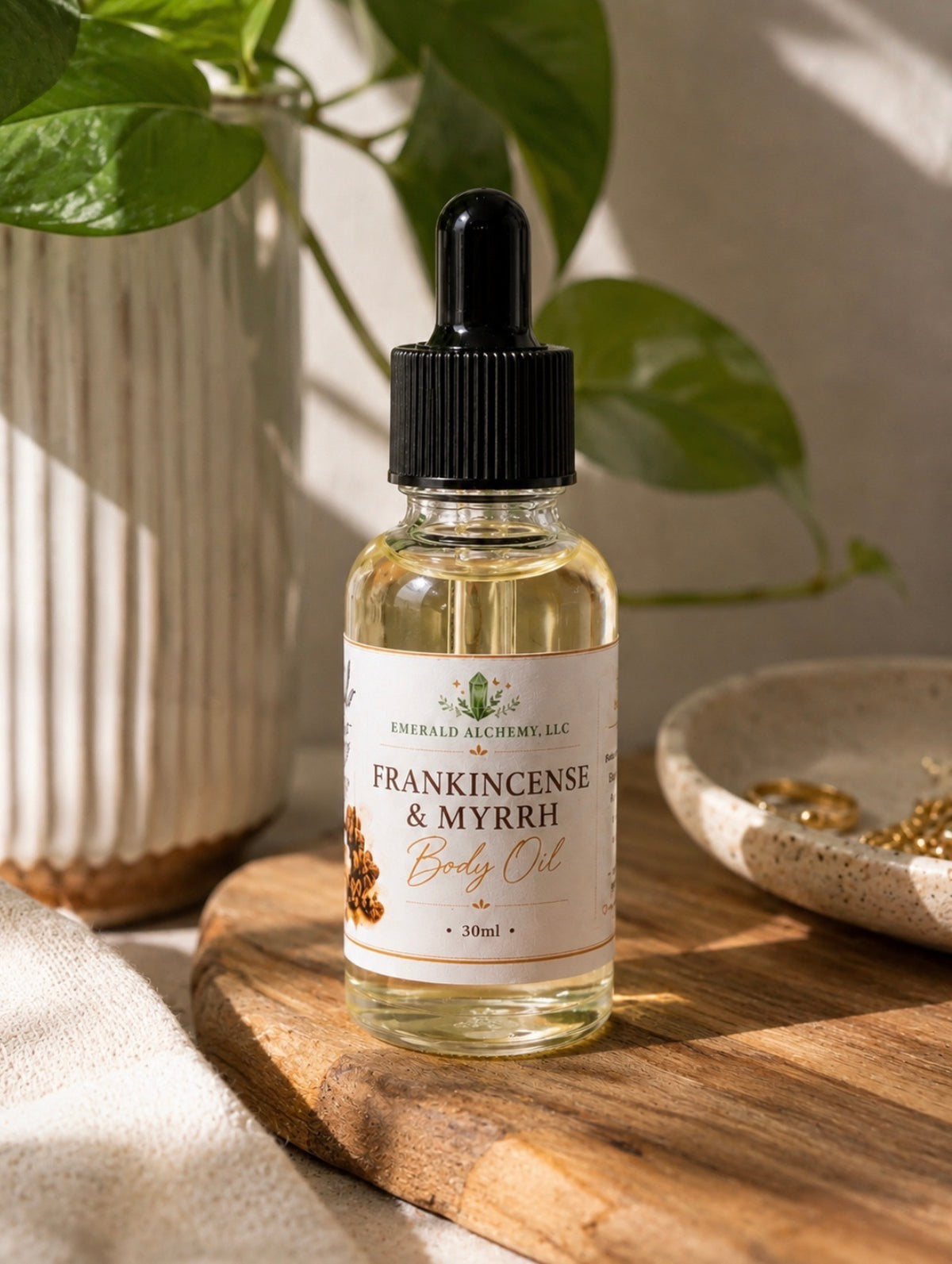 One ounce Frankincense and Myrrh Body Oil displayed with greenery