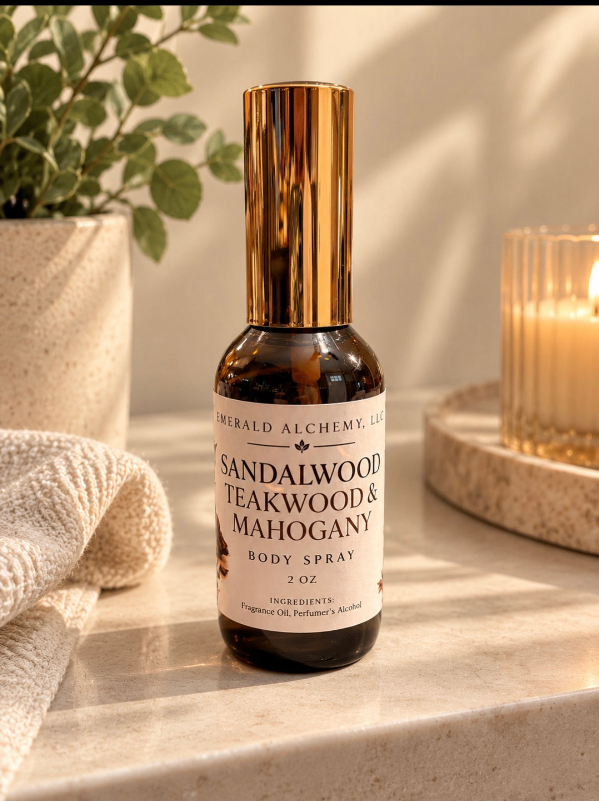 Sandalwood Teakwood and Mahogany 2 oz body spray standing beside candle and greenery